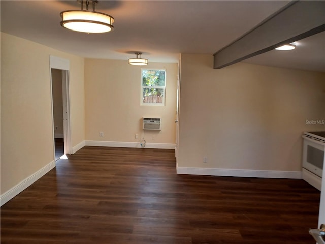 unfurnished room featuring dark wood-type flooring, a wall mounted air conditioner, beam ceiling, and baseboards