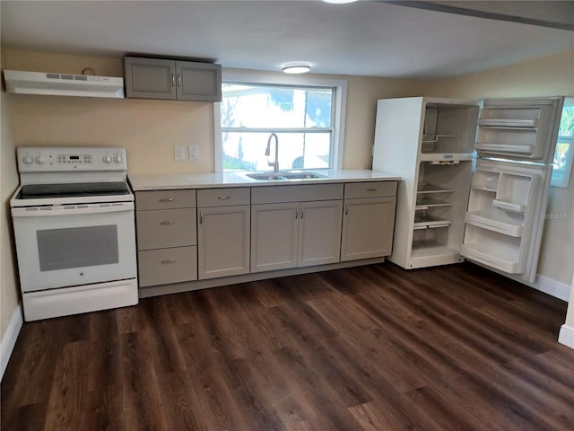 kitchen with light countertops, electric range, a sink, and under cabinet range hood