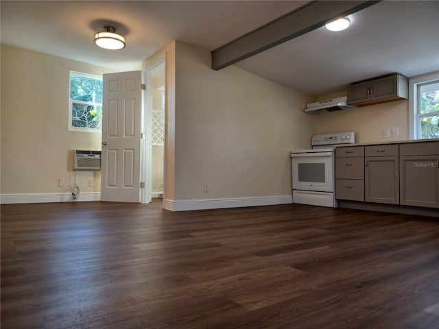 kitchen with dark wood-style floors, electric range, gray cabinetry, an AC wall unit, and under cabinet range hood