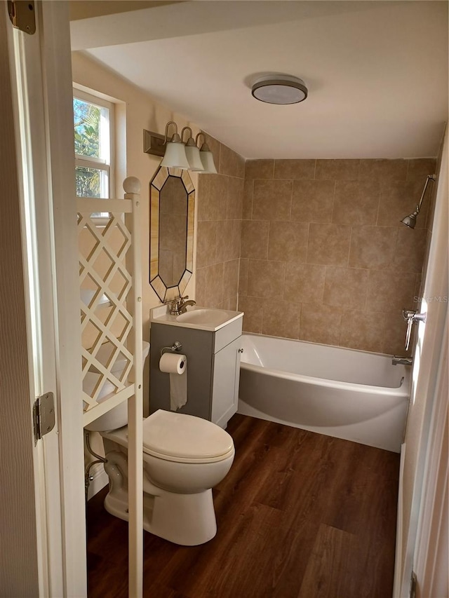 bathroom with shower / tub combination, vanity, toilet, and wood finished floors