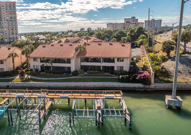 birds eye view of property with a water view and a city view