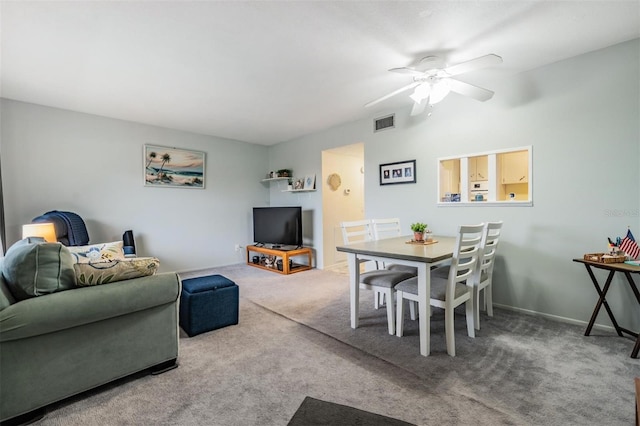 living room featuring a ceiling fan, baseboards, visible vents, and carpet flooring