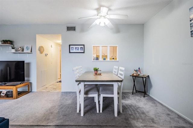 carpeted dining area with a ceiling fan, visible vents, and baseboards