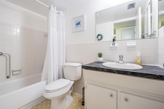 bathroom featuring toilet, visible vents, tile walls, tile patterned floors, and shower / bathtub combination with curtain