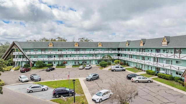 view of property with uncovered parking and a residential view