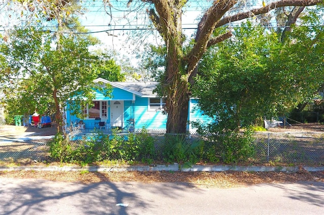 bungalow with a porch and fence