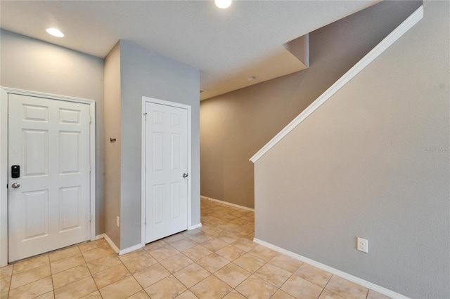 interior space with light tile patterned floors, baseboards, and recessed lighting