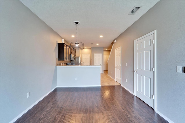 unfurnished living room featuring recessed lighting, visible vents, baseboards, and wood finished floors