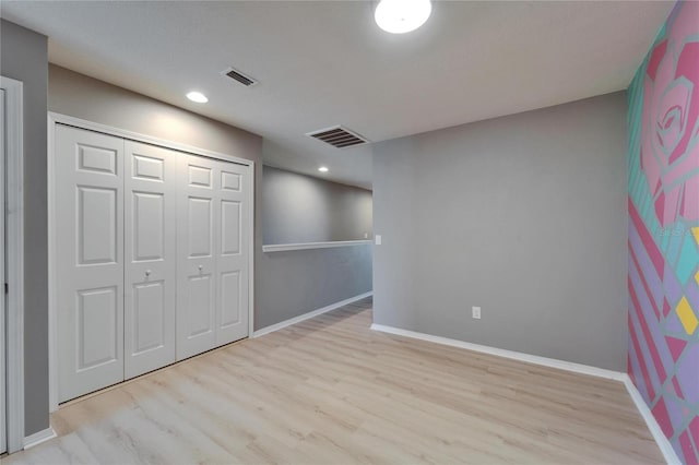 unfurnished bedroom with baseboards, visible vents, and wood finished floors