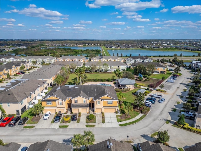 birds eye view of property featuring a residential view and a water view