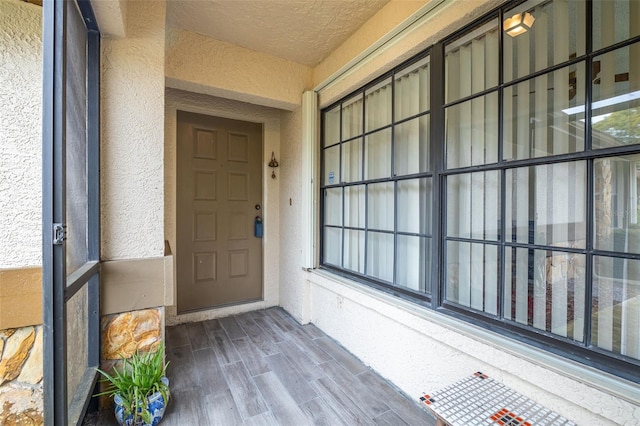 entrance to property featuring stucco siding