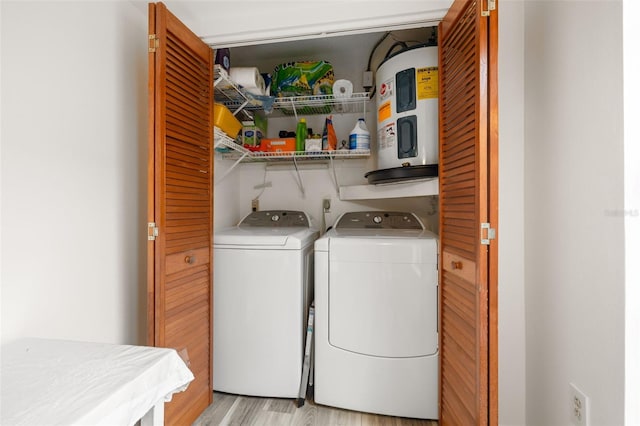 laundry area featuring light wood-type flooring, laundry area, and washing machine and clothes dryer