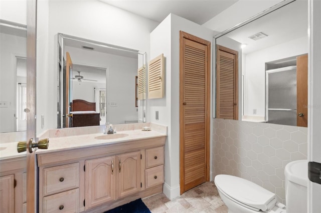 full bathroom featuring a closet, visible vents, toilet, vanity, and ensuite bath