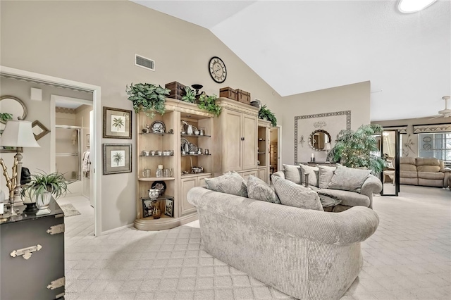 living room featuring light carpet, high vaulted ceiling, ceiling fan, and visible vents