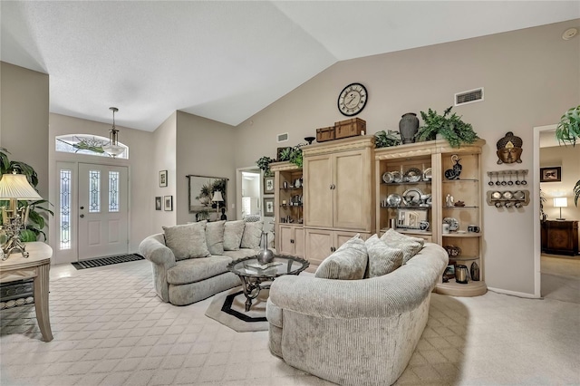 living room with visible vents, vaulted ceiling, light carpet, and baseboards