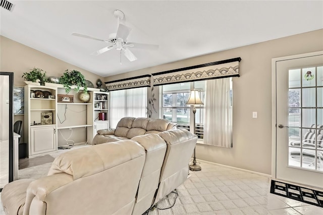 carpeted living room featuring ceiling fan, vaulted ceiling, visible vents, and baseboards