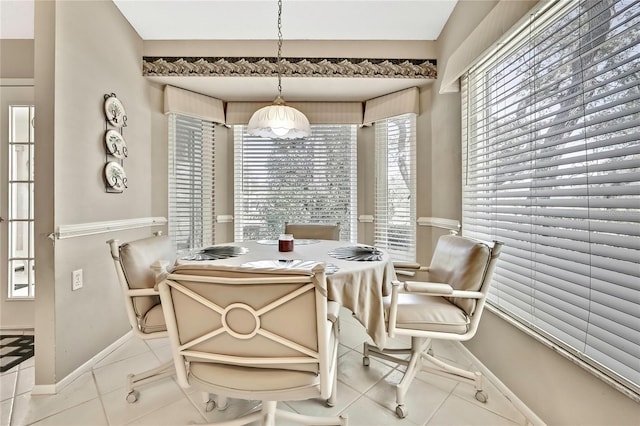 dining space with tile patterned flooring and baseboards