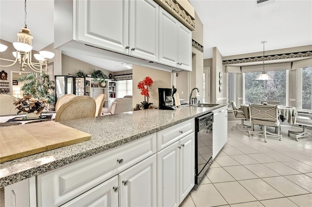 kitchen with black dishwasher, light tile patterned flooring, a sink, and white cabinetry