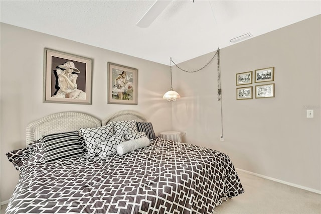 bedroom with visible vents, a ceiling fan, carpet flooring, a textured ceiling, and baseboards