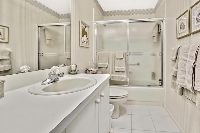 full bath with enclosed tub / shower combo, vanity, tile patterned flooring, and toilet