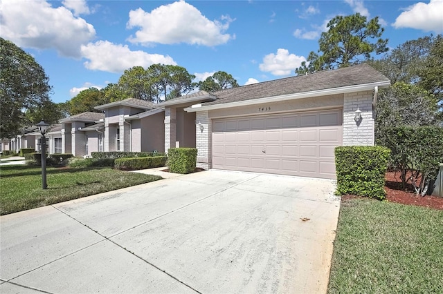 view of front of property with brick siding, a front yard, a garage, stone siding, and driveway