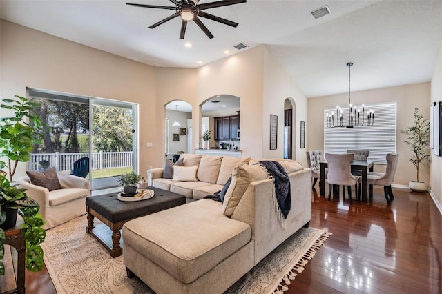 living area with baseboards, visible vents, hardwood / wood-style floors, and ceiling fan with notable chandelier