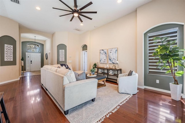 living room with hardwood / wood-style flooring, baseboards, arched walkways, and recessed lighting