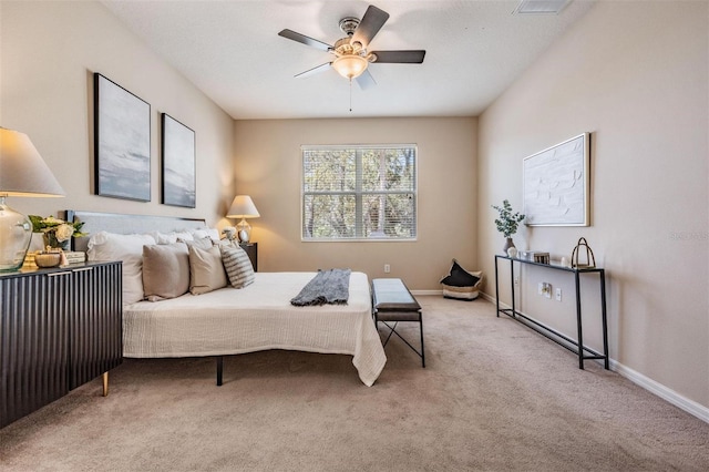 carpeted bedroom featuring ceiling fan and baseboards