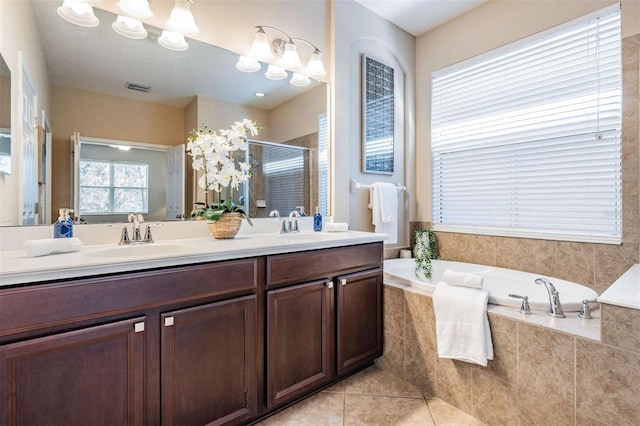 full bathroom featuring visible vents, tile patterned floors, a garden tub, a shower stall, and a sink