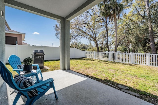 view of patio featuring a fenced backyard and a grill