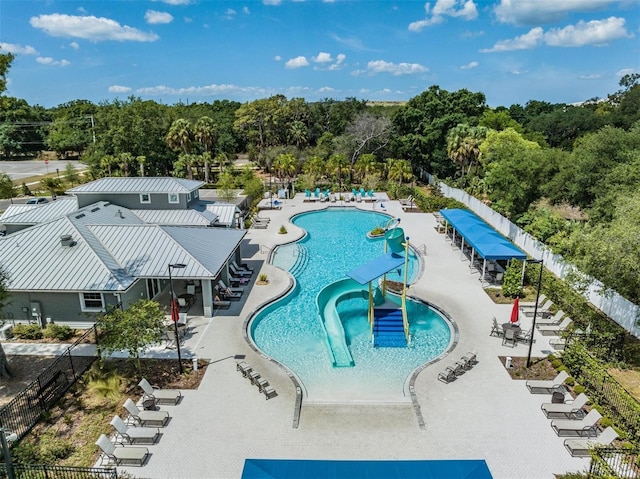 pool with a patio and fence