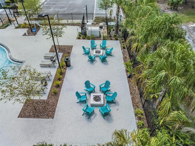 surrounding community featuring a fire pit, a patio, and fence