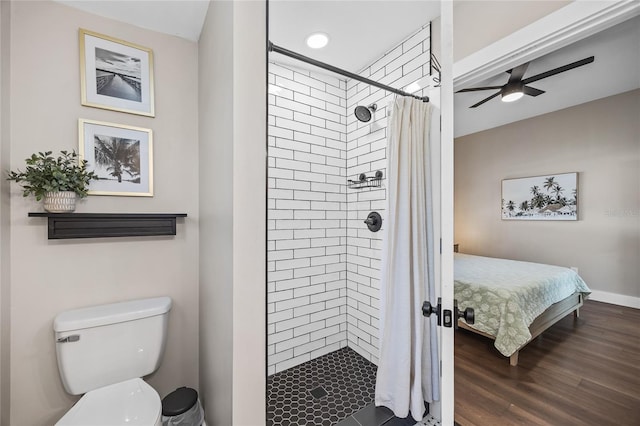 bathroom with toilet, a shower stall, wood finished floors, and ensuite bathroom