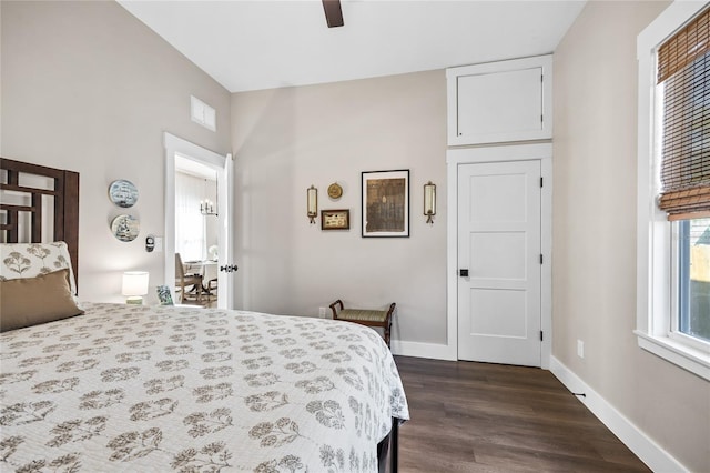 bedroom with dark wood-type flooring, a ceiling fan, visible vents, and baseboards