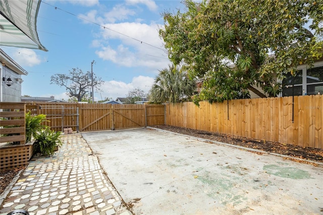 view of patio with a gate and fence