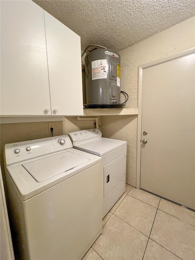 laundry room featuring cabinet space, light tile patterned floors, independent washer and dryer, a textured ceiling, and water heater