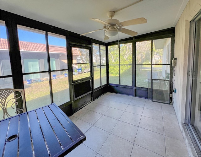 unfurnished sunroom with ceiling fan