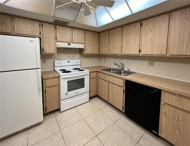 kitchen featuring light tile patterned floors, visible vents, a sink, white appliances, and under cabinet range hood