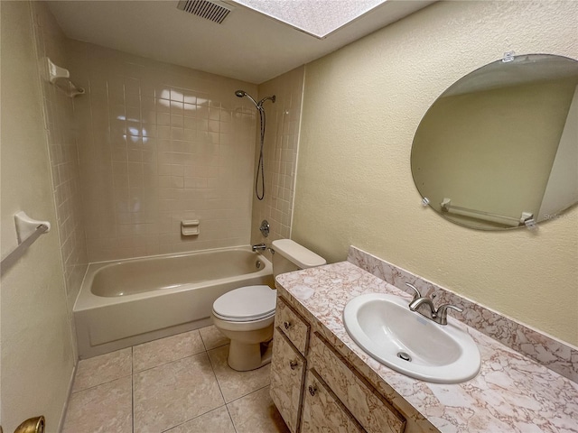 bathroom with bathing tub / shower combination, visible vents, toilet, vanity, and tile patterned floors