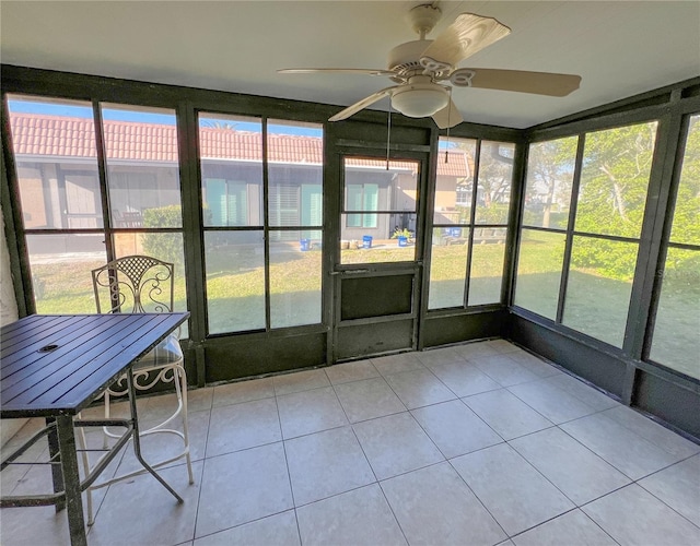 unfurnished sunroom featuring a ceiling fan