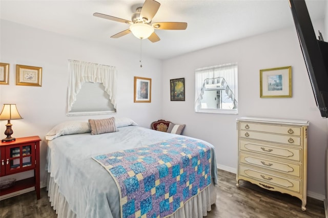 bedroom with a ceiling fan, wood finished floors, and baseboards