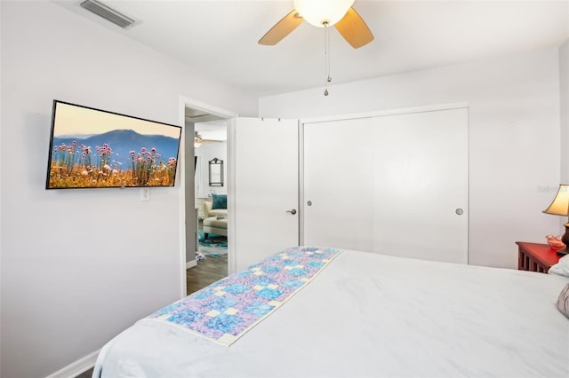 bedroom with visible vents, baseboards, a closet, and ceiling fan