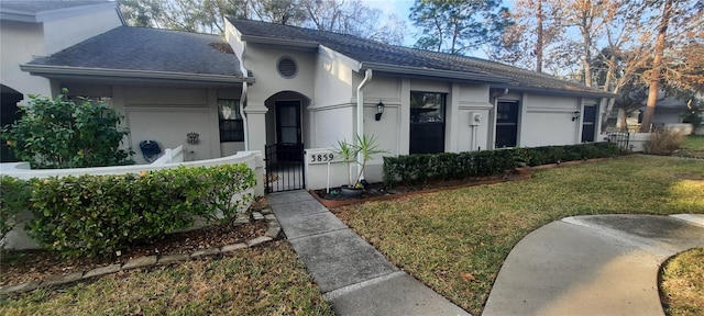 single story home featuring fence, roof with shingles, a gate, stucco siding, and a front lawn