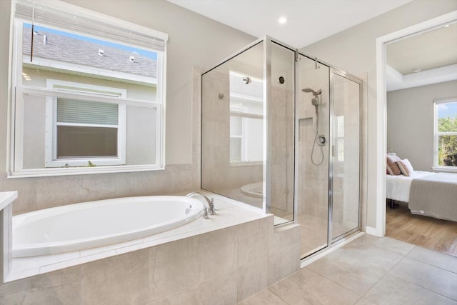 ensuite bathroom with a garden tub, a shower stall, ensuite bathroom, and tile patterned floors