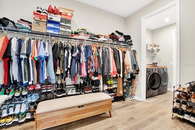 walk in closet with washer and clothes dryer and wood finished floors