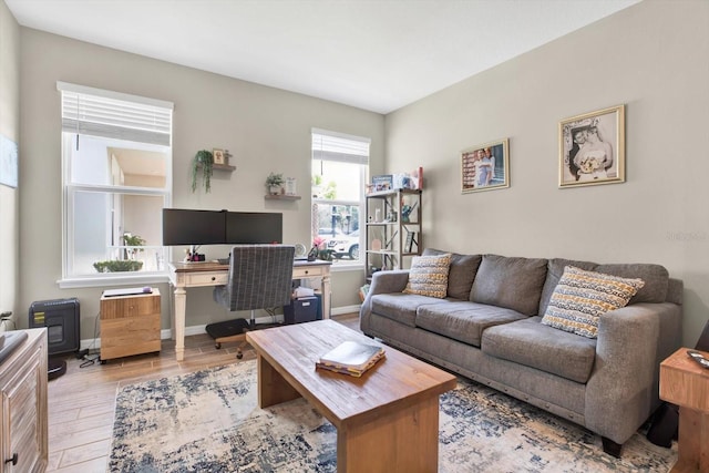 living room featuring baseboards and wood finished floors