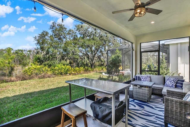 sunroom featuring ceiling fan