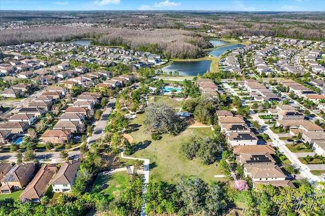 birds eye view of property with a water view and a residential view