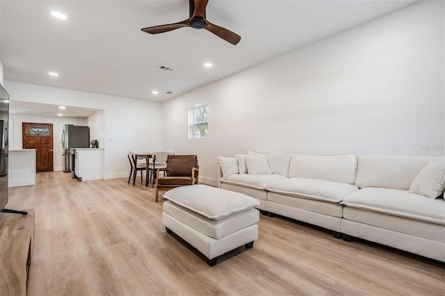 living area featuring baseboards, visible vents, a ceiling fan, light wood-style floors, and recessed lighting