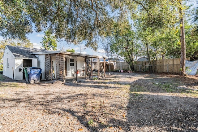 back of house with fence